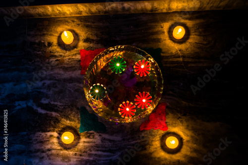 Happy Diwali - rangoli painting on floor for diwali with floating candles 