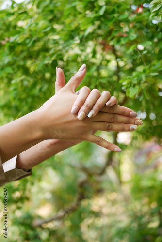 woman hand with beige colour manicure nails © SYAHMI