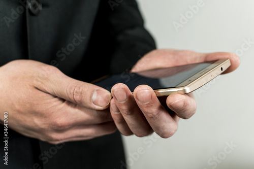 Close up of the hands taking a mobile.