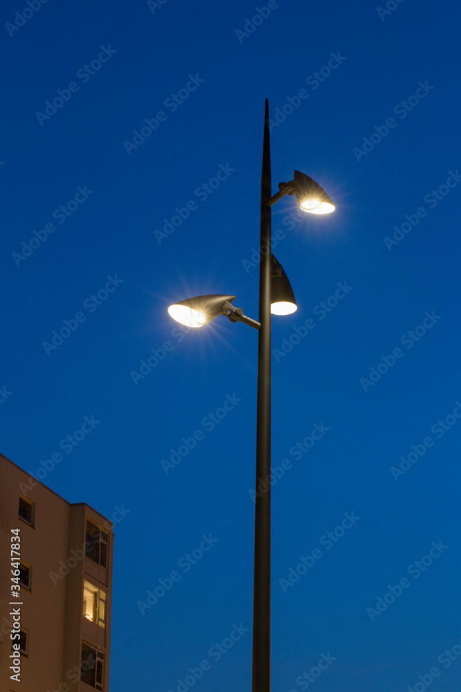 Modern lamp posts at night. Twilight