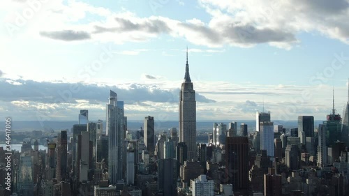 Quarter orbiting smooth aerial of Empire State Building skyline at golden hour photo