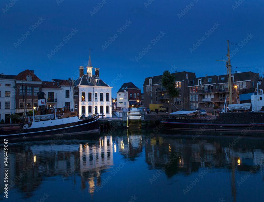 City of Schiedam at night. Twilight. Harbour and boats.