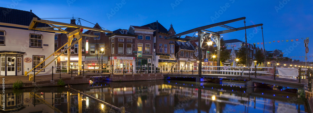 City of Schiedam at night. Twilight. Draw bridge and canal. Panorama