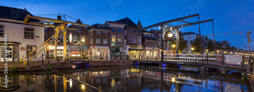 City of Schiedam at night. Twilight. Draw bridge and canal. Panorama