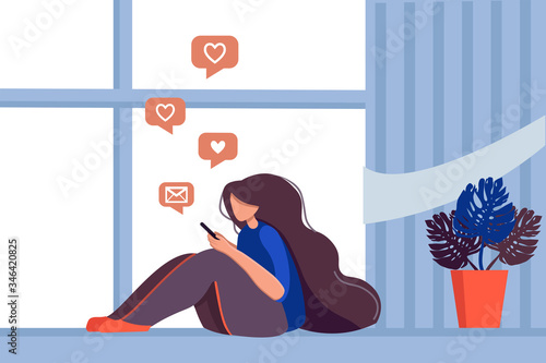Stay home concept. Young woman on a couch with a smartphone chatting on social networks and receiving messages or mail.
