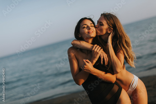 Young women having fun at summer vacations on the beach