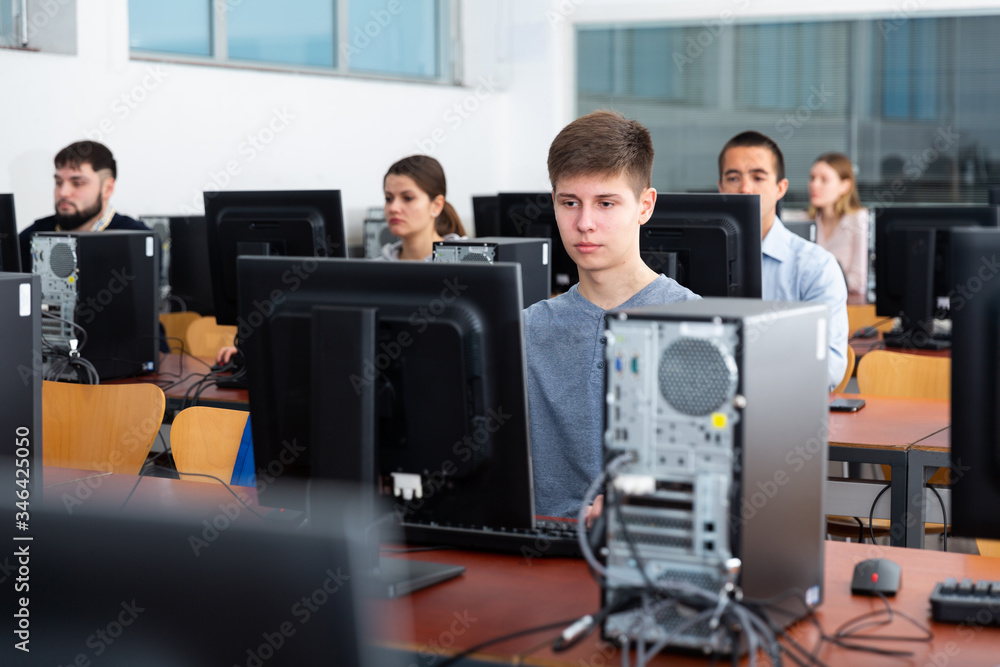 Fototapeta premium Female and male students working on computers