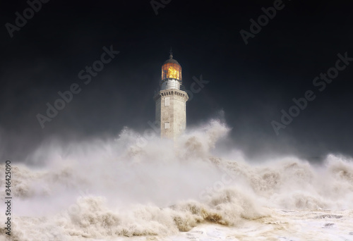 lighthouse at night with storm and waves splashing