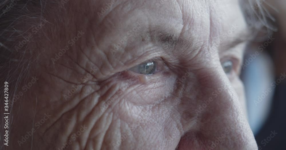 The face and eyes of an old woman. Large wrinkles on the face of an old woman. Face close up. A senior citizen looks into the distance. The face and eyes of an old woman. Large wrinkles on the face of an old woman. Face close up. A senior citizen looks into the distance.