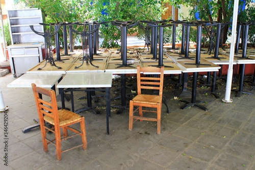 Athens  Greece  May 6 2020 - Tables and chairs stacked outside closed cafe-restaurant during the Coronavirus lockdown.