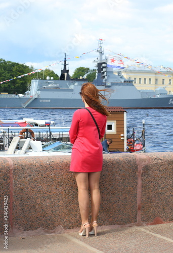 The girl in the red dress on the embankment  Angliyskaya naberegnaya, Saint Petersburg, Russia, September 2018 photo