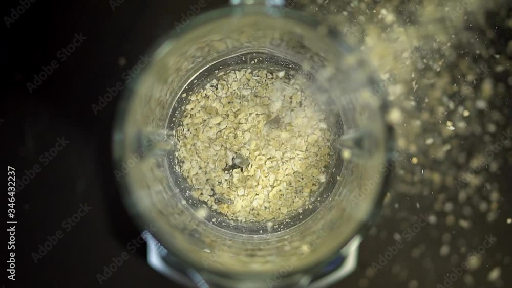 In a blender coffee, cocoa, Cola from above falls cereals porridge oatmeal. Smoothies drinks food in the mixer. Healthy food from fruits and vegetables, porridge.