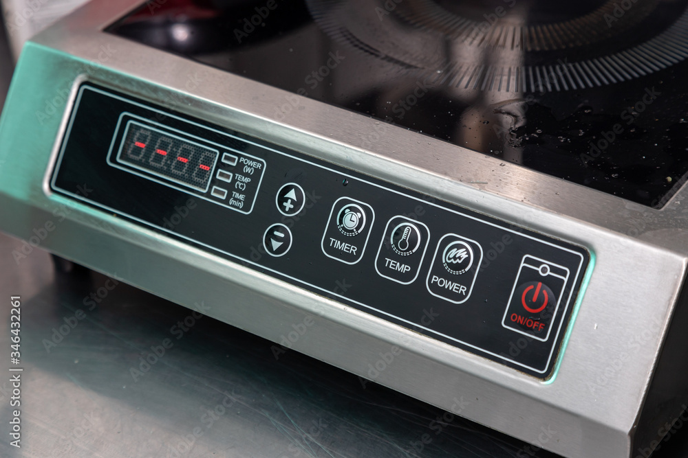 Obraz premium Close-up of the power button, temperature changes and other settings on the electric stove