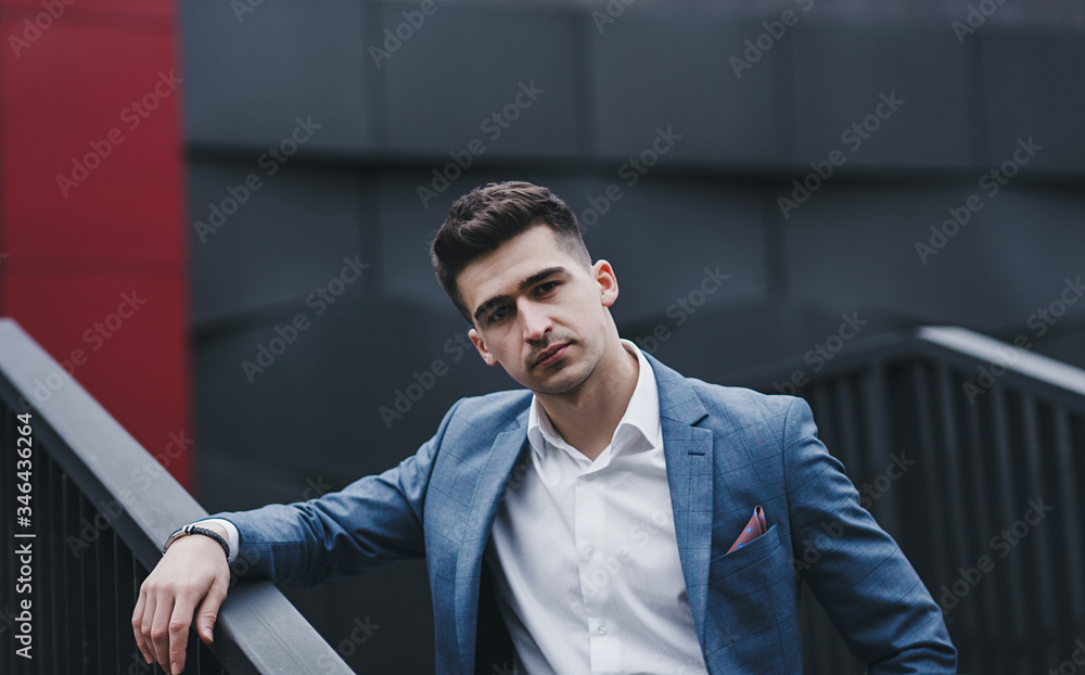 Sexy gorgeous stylish man. City style. A beautiful and charming man with outdoors. White shirt and stylish jacket Sexy gorgeous stylish man. City style. A beautiful and charming man with outdoors. White shirt and stylish jacket