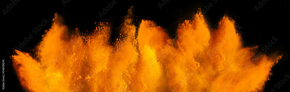 orange red holi paint color powder explosion isolated dark black background. industry beautiful party festival concept - obrazy, fototapety, plakaty 
