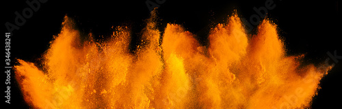 Obraz na płótnie orange red holi paint color powder explosion isolated dark black background