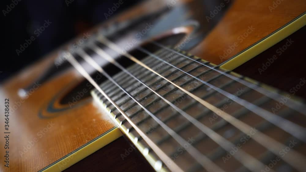 Close up macro on guitar or chords with focus shift on strings. Musical instrument concept. Music and sound Close up macro on guitar or chords with focus shift on strings. Musical instrument concept. Music and sound
