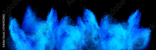 cyan blue holi paint color powder explosion isolated  dark black background. industry beautiful party festival concept