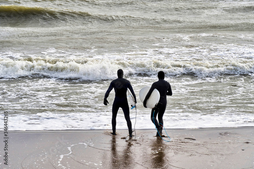 Two surfer friends. Sports time together.