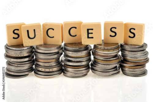 Success written with letters on stacks of coins