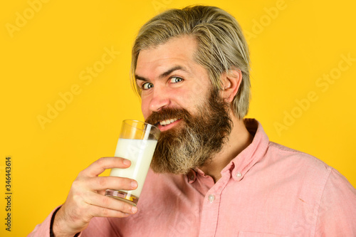 Emotional bearded man hold glass of milk. Vegan milk concept. Vegan milks made from wide variety of beans nut, seeds and grains. Healthy food. Drink protein cocktail. Lactose free. Pasteurized milk