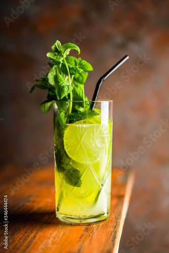 Mojito cocktail with lime and mint on the rustic background. Selective focus. Shallow depth of field.