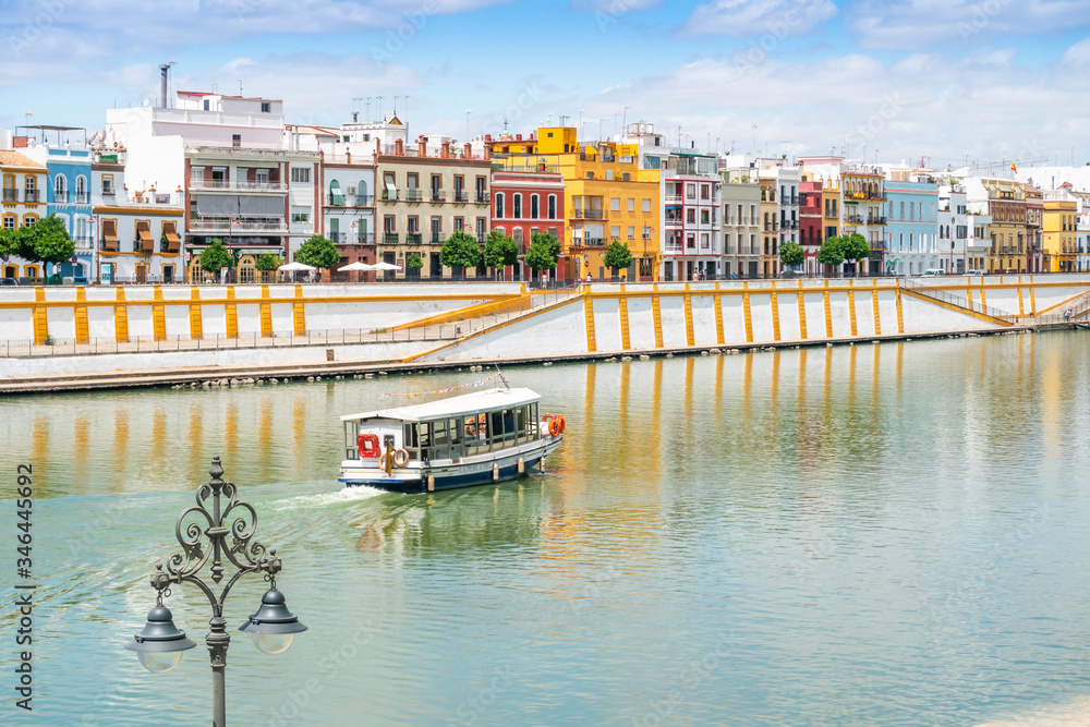 Naklejka premium Boat cruise on Guadalquivir river in city center of Seville, Spain