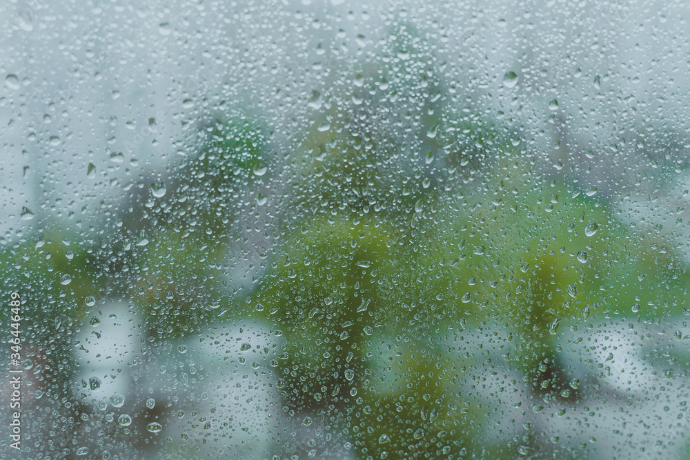 grey rainy droplets on a window glass. surface. drops on window shield in a rainy days in a city. stormy weather. rainy season. stormy weather. isolation sad depression concept. rainy season. grey rainy droplets on a window glass. surface. drops on window shield in a rainy days in a city. stormy weather. rainy season. stormy weather. isolation sad depression concept. rainy season.