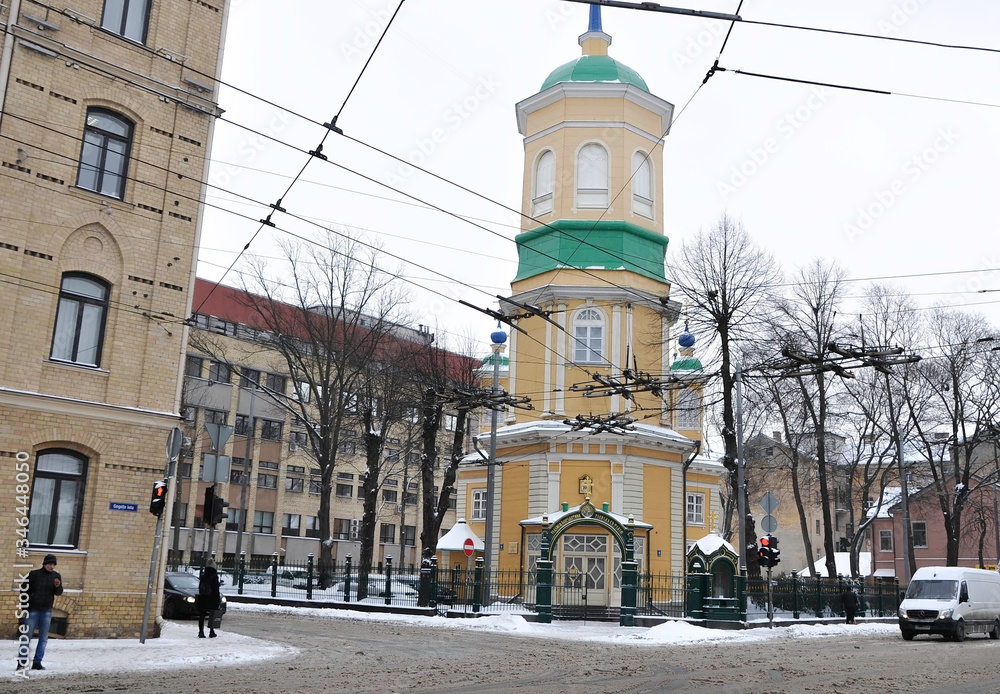 Yellow church with green doors and surrounded by snow in Riga, Latvia.