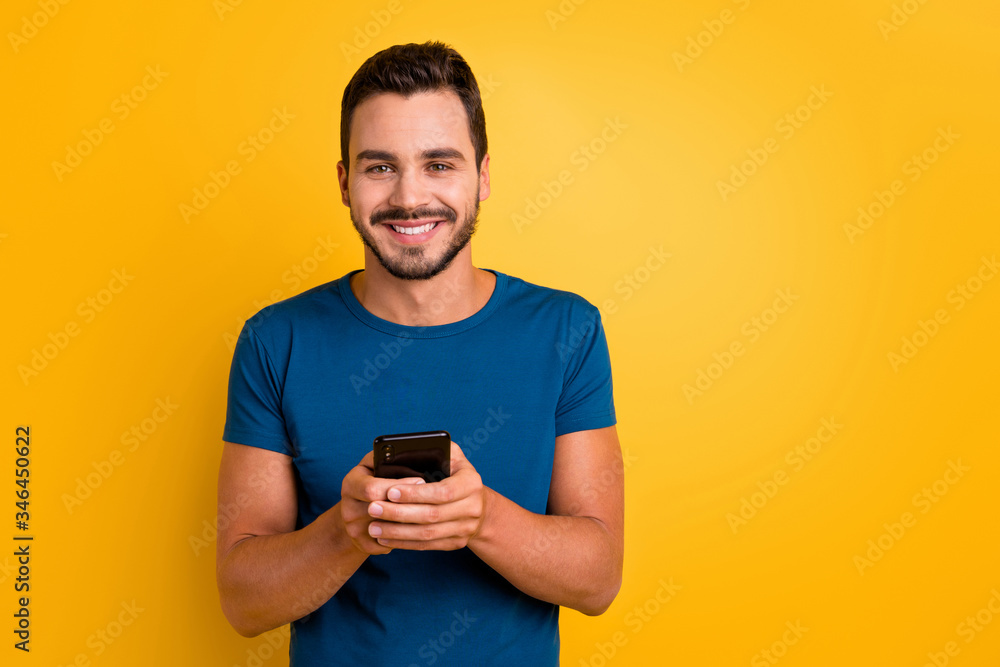 Close-up portrait of his he nice attractive glad cheerful cheery guy using cell comment feedback repost smm service isolated over bright vivid shine vibrant yellow color background Close-up portrait of his he nice attractive glad cheerful cheery guy using cell comment feedback repost smm service isolated over bright vivid shine vibrant yellow color background