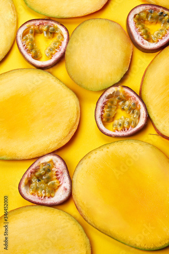 Vertical flat layout of mango slices on yellow paper background