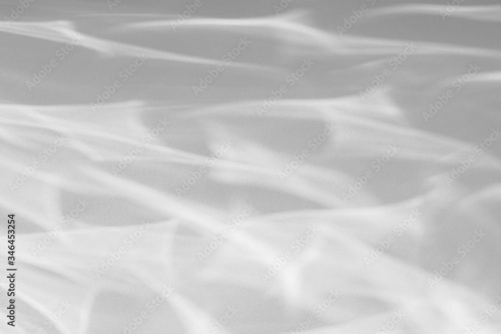 Obraz premium Geometric texture overlay effect for photo and mockups. Organic drop diagonal shadow and light caustic effect on a white wall. Shadows for natural light effects