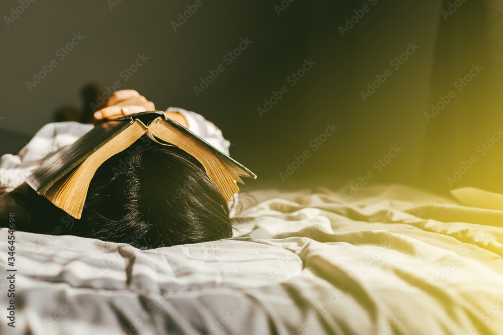 Φωτογραφία young woman sleep and holding the bible on head in morning, worship and pray