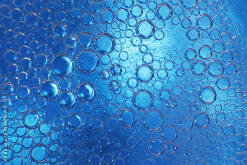 abstract light blue background with oil circles .  bubbles of water close up . oil bubbles in the water macro.  circle bubbles  background