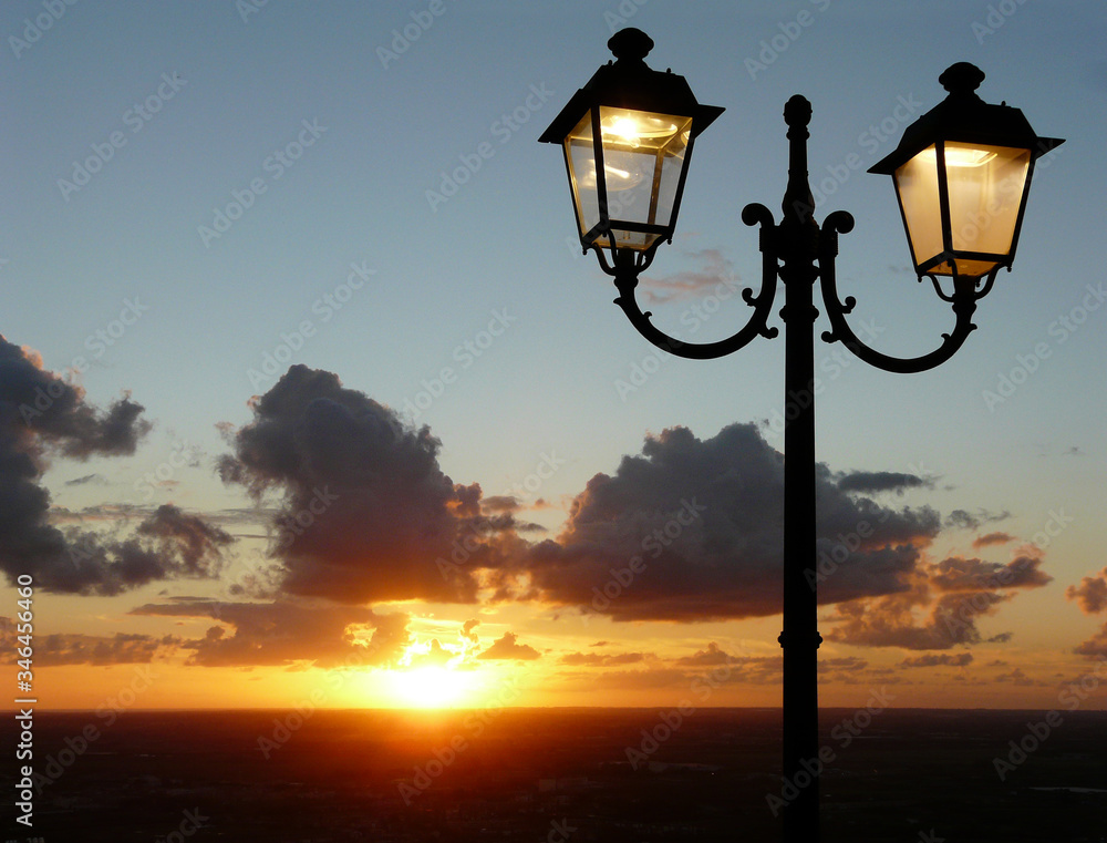 sunset with lit street lamp