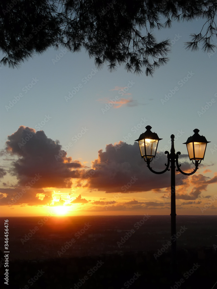 sunset with lit street lamp