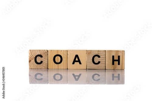 Wooden cubes with coach lettering on white background