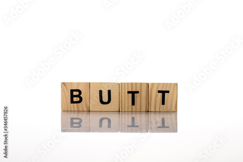 Wooden cubes with butt lettering on white background