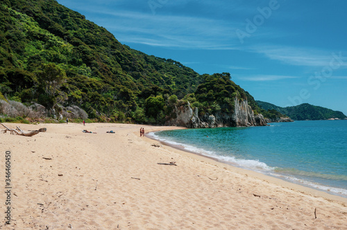 Couple on the beach in front of a cliff at Abel Tasman National Park. Anapai Bay. © Johan