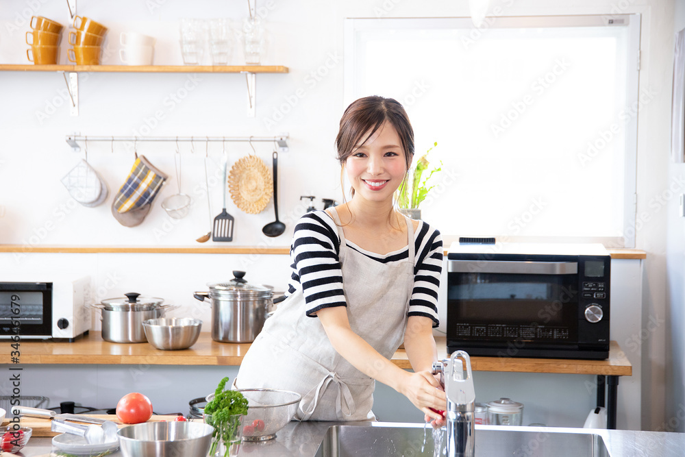 キッチンで料理を作る若い女性 キッチンで料理を作る若い女性