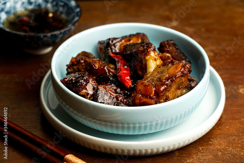 aian food, caramelized pork ribs, dark   wooden background, chinese food