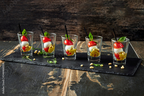 Caprese salad in a row - skewer with tomato, mozzarella and basil, italian food and healthy vegetarian diet concept photo