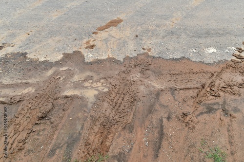 tire track on diry soil and asphalt road for background