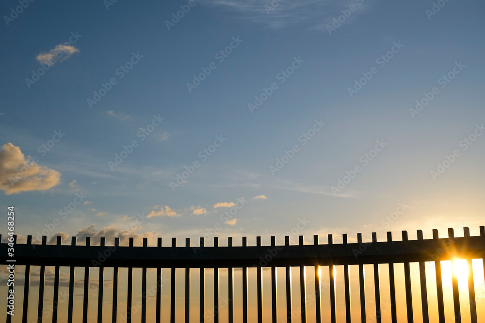 Fence against the sky at sunrise