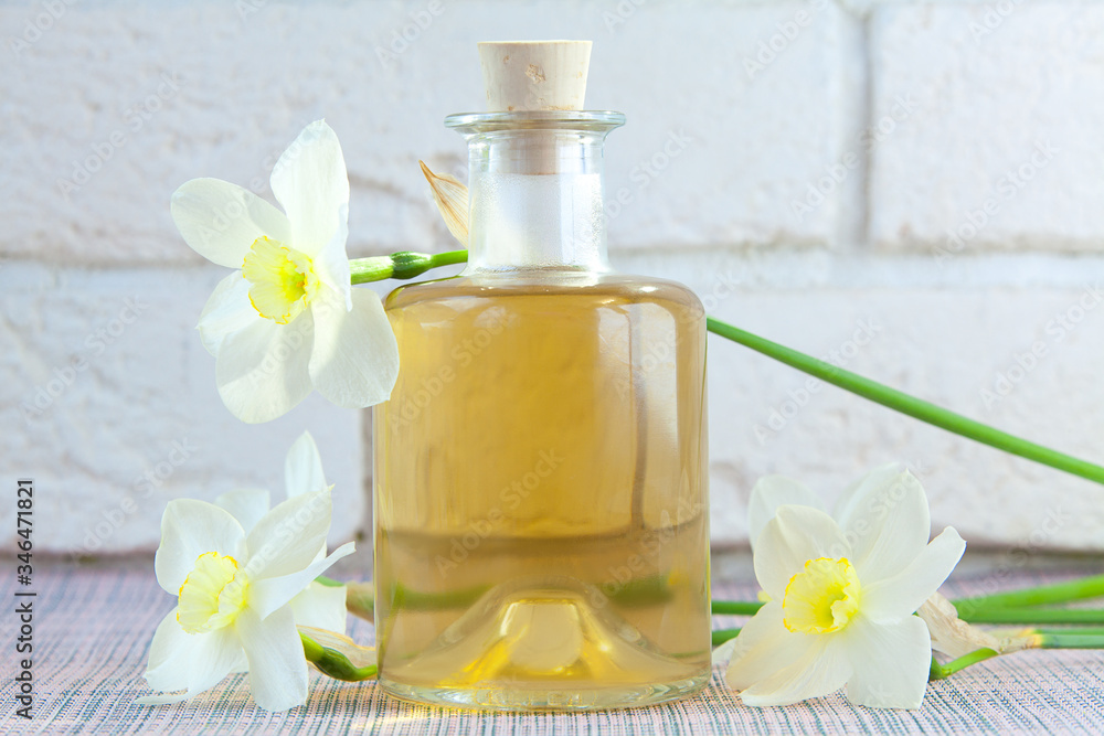Essence of flowers on white in beautiful glass jar Essence of flowers on white in beautiful glass jar