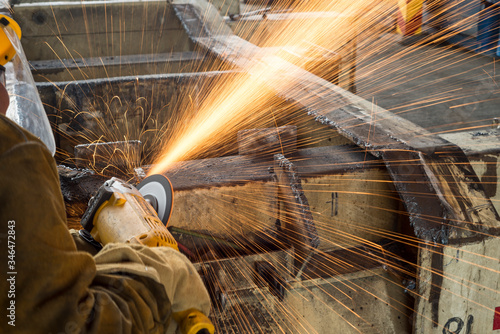 Working with grinding machine in a truck, Industrial worker