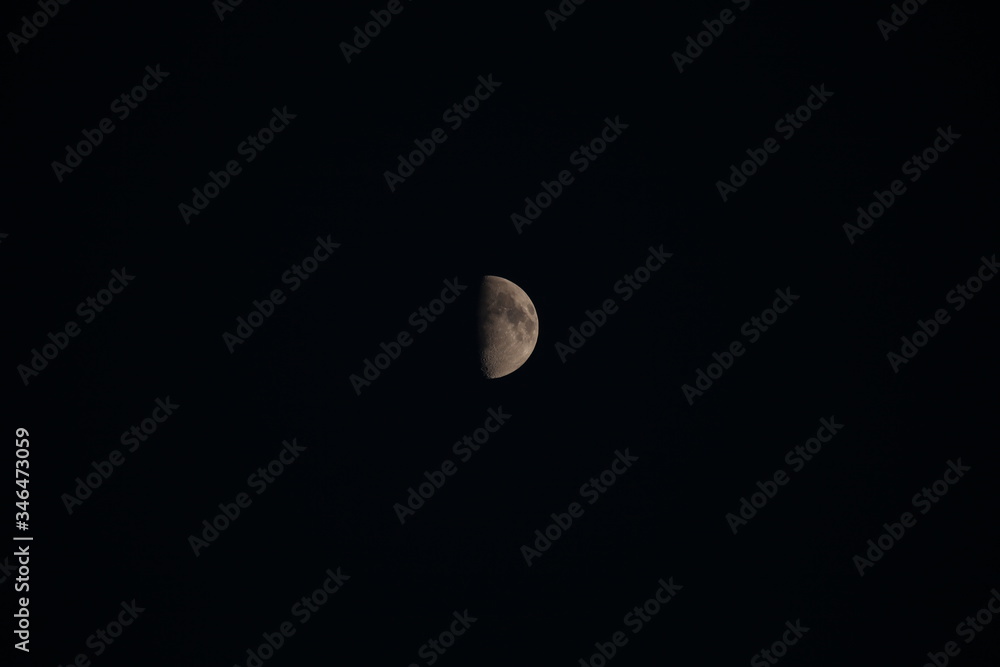 Half of the Moon in the night sky Half of the Moon in the night sky