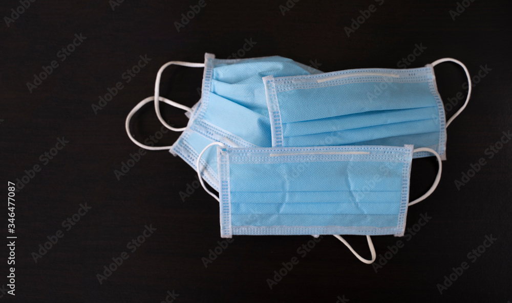 Medical face mask place on a wooden table