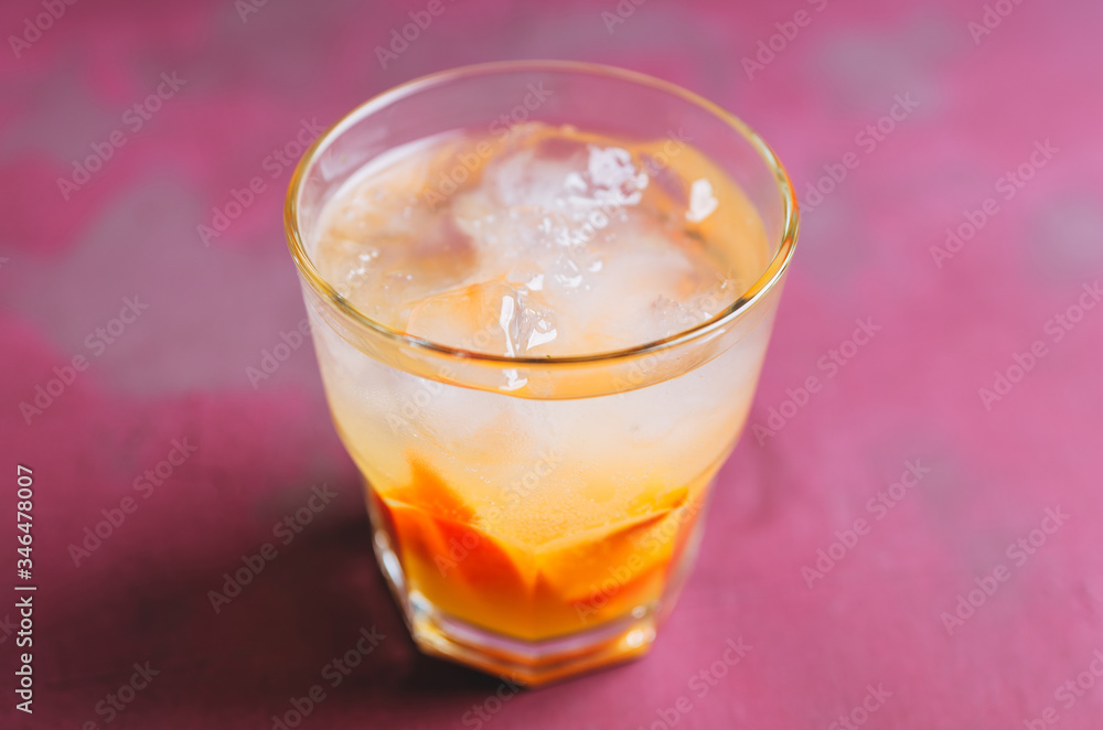Old fashioned beverage with orange slices on rustic background. Selective focus. Shallow depth of field. Old fashioned beverage with orange slices on rustic background. Selective focus. Shallow depth of field.