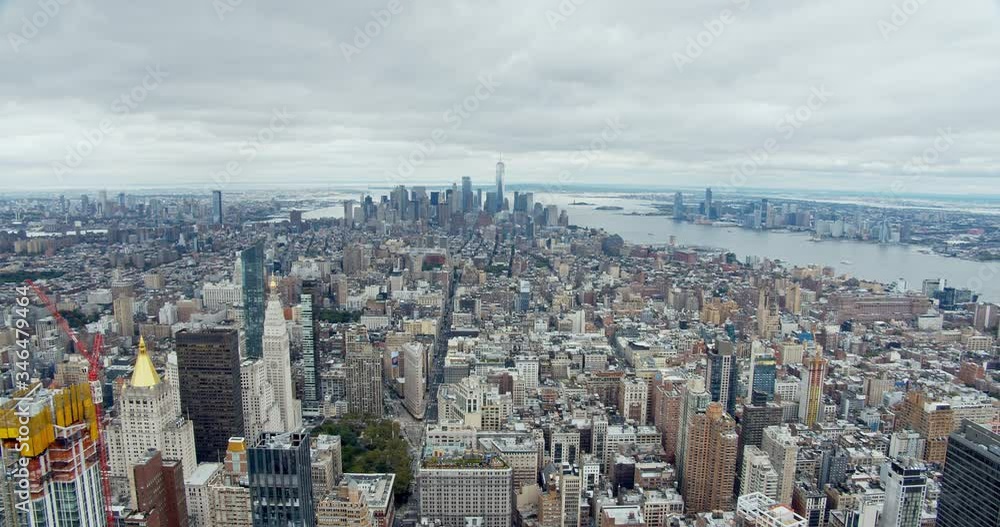 Scenic wide shot of lower Manhattan with financial district, World Trade Center, Flatiron building, East River and Hudson River framing New York City, filmed from vantage point. Scenic wide shot of lower Manhattan with financial district, World Trade Center, Flatiron building, East River and Hudson River framing New York City, filmed from vantage point.